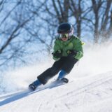 a young boy skiing on a mountain
